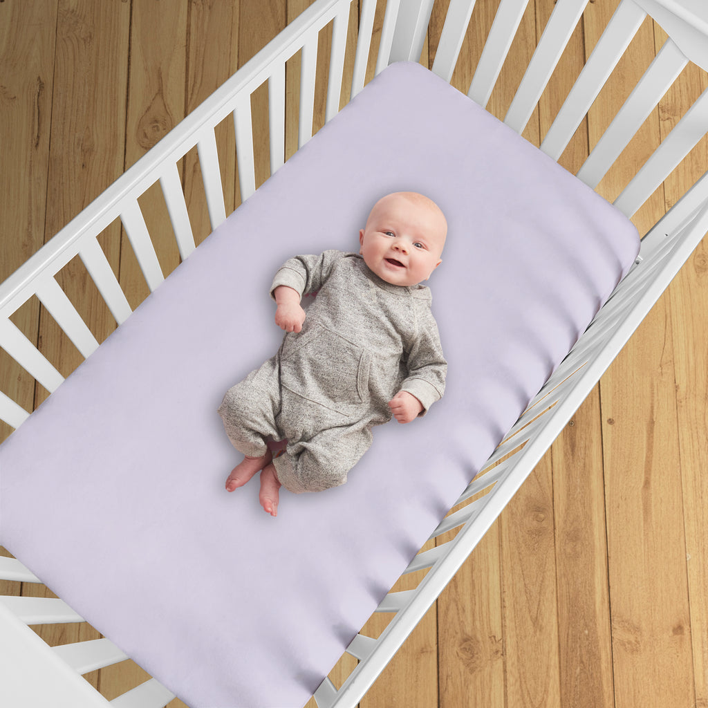 BreathableBaby All-in-One Fitted Sheet & Waterproof Cover for Crib Mattresses in Lavender Shown in Crib