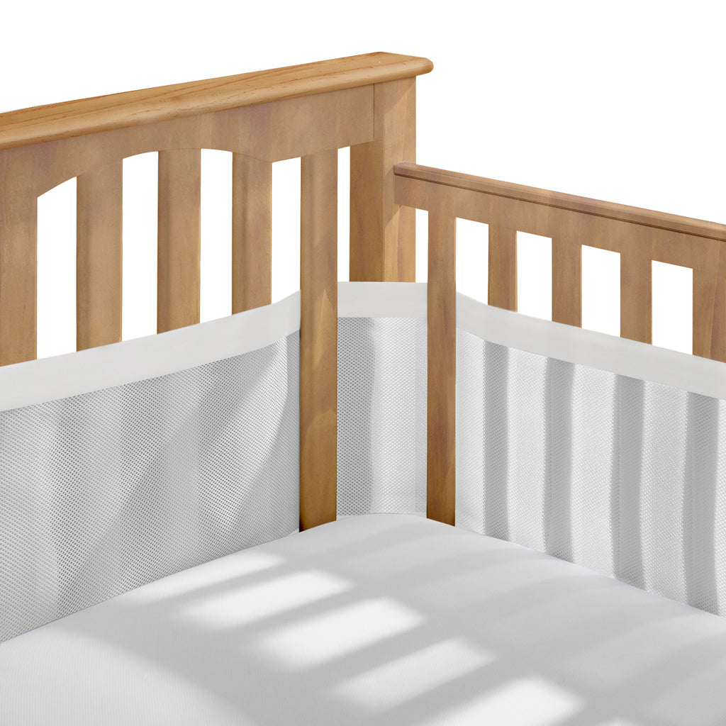 Corner view of BreathableBaby Breathable Mesh Crib Liner – Deluxe Muslin Collection on a crib in White Mist