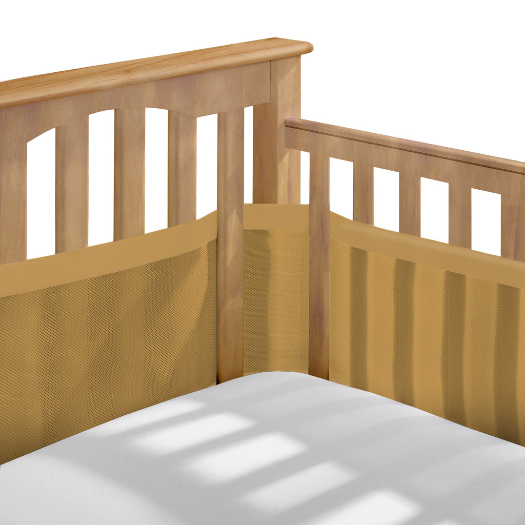 Corner view of BreathableBaby Breathable Mesh Crib Liner – Deluxe Muslin Collection on a crib in Golden Sunrise