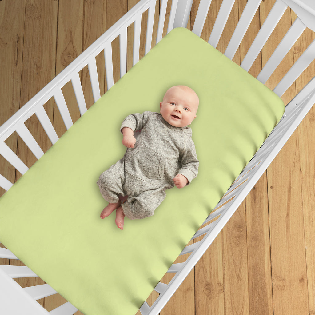 BreathableBaby All-in-One Fitted Sheet & Waterproof Cover for Crib Mattresses in Lime Shown in Crib
