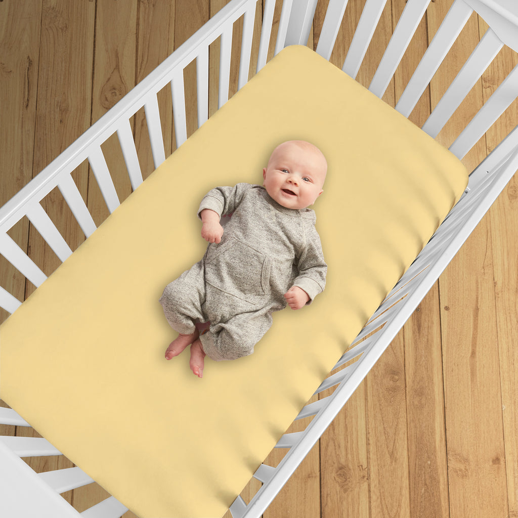 BreathableBaby All-in-One Fitted Sheet & Waterproof Cover for Crib Mattresses in Yellow Shown in Crib
