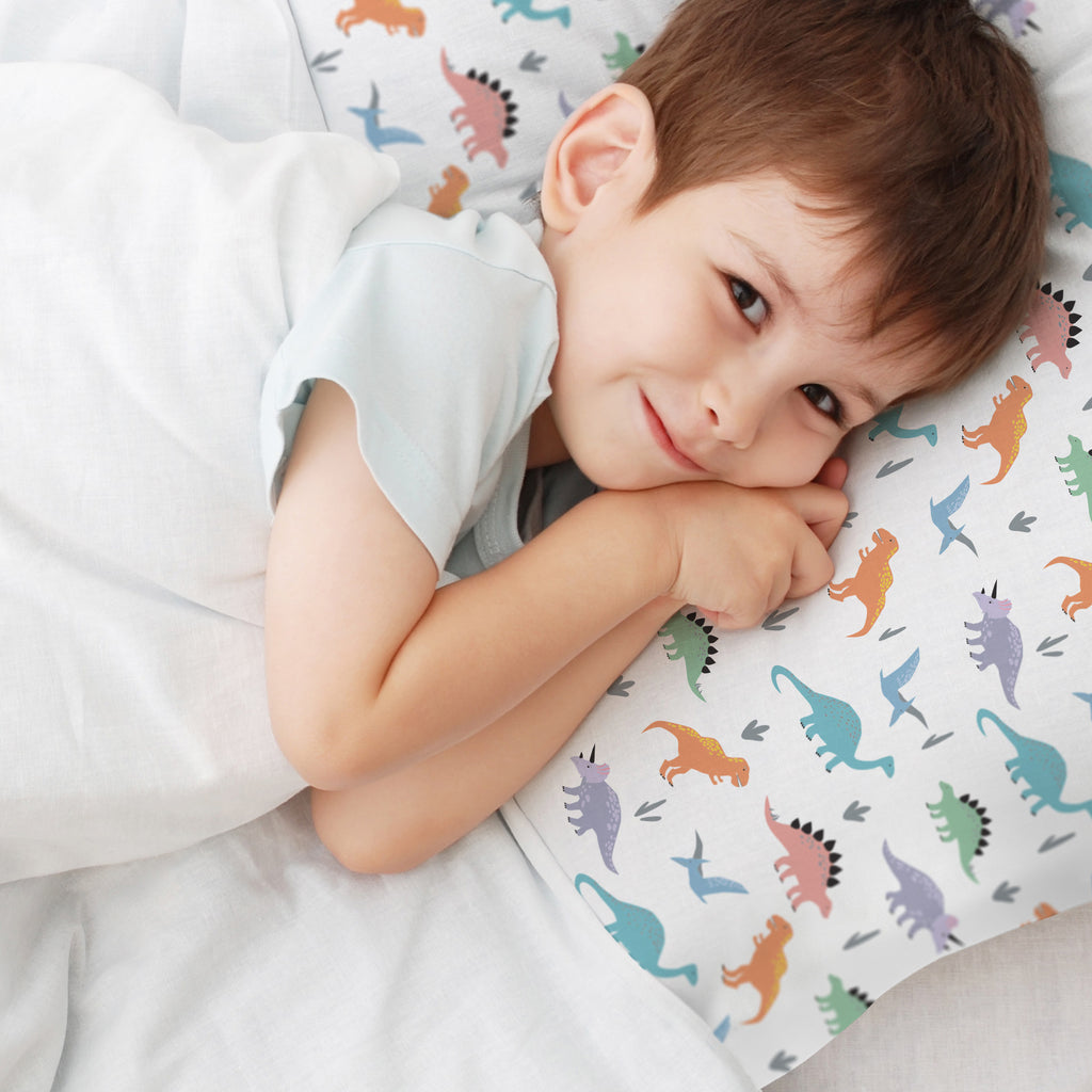 Child using BreathableBaby Cotton Percale Pillowcase for Toddler Pillow in Dinosaurs