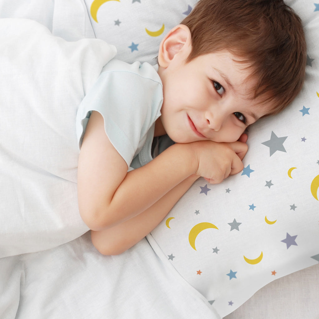 Child using BreathableBaby Cotton Percale Pillowcase for Toddler Pillow in Moon & Stars