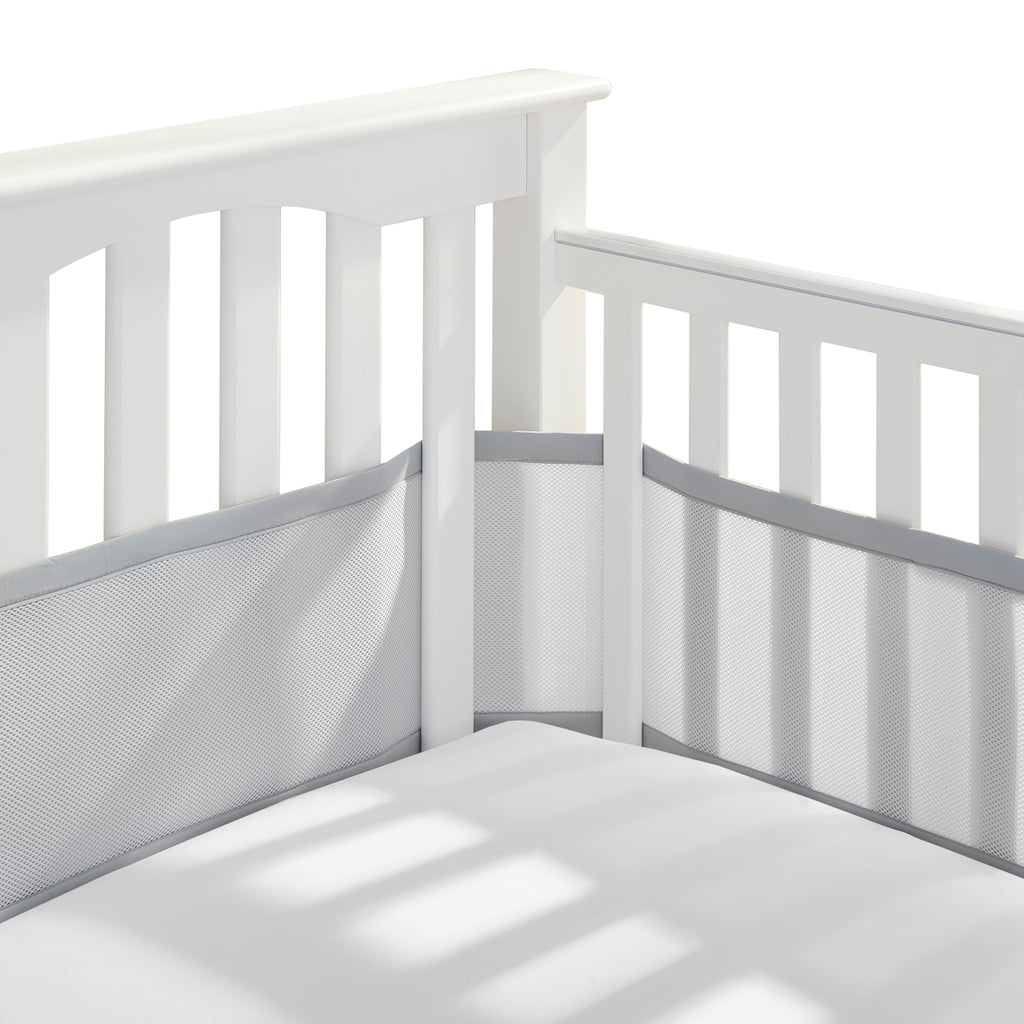 Corner view of BreathableBaby Breathable Mesh Crib Liner on a crib in Gray