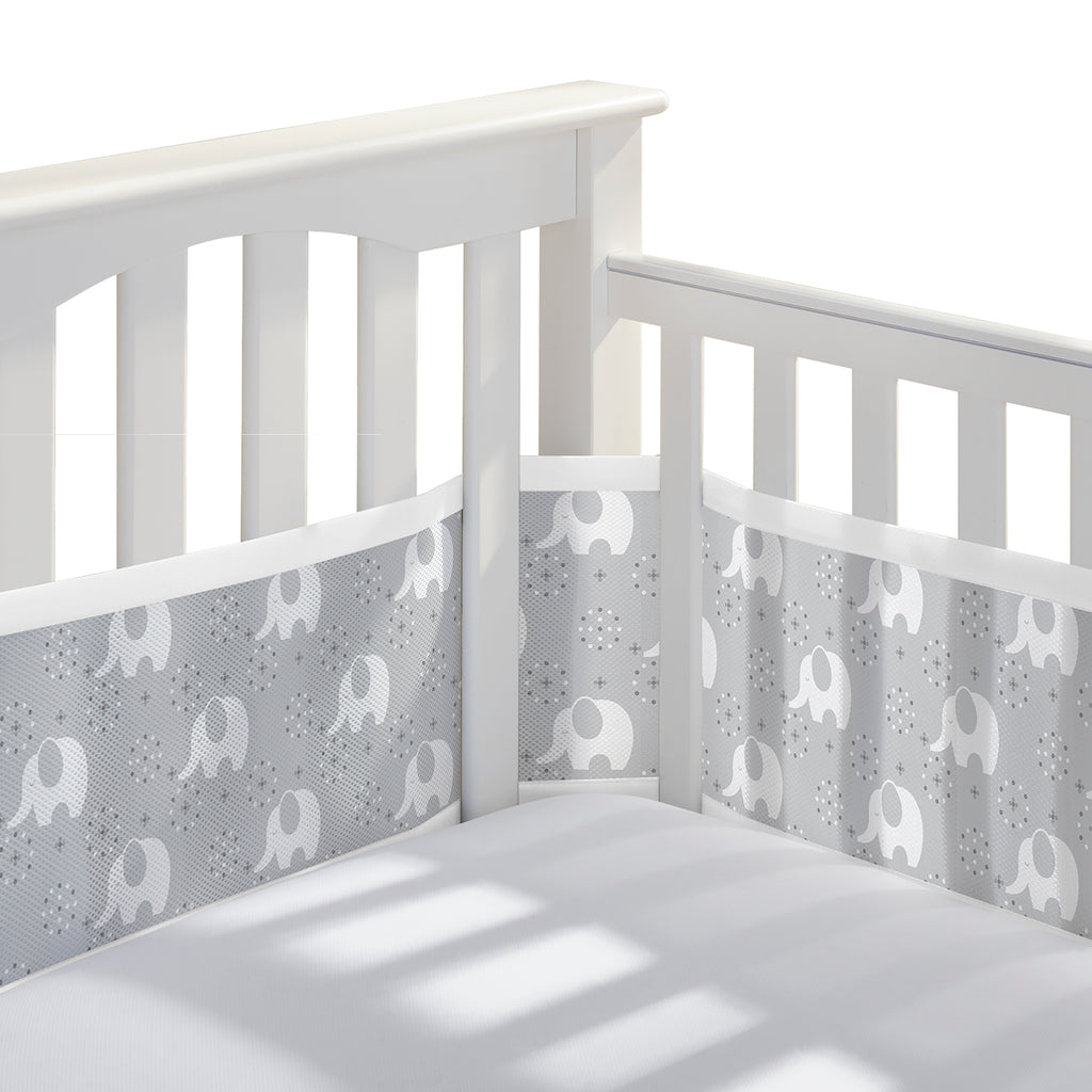 Corner view of BreathableBaby Breathable Mesh Crib Liner on a crib in Peaceful Elephant Gray