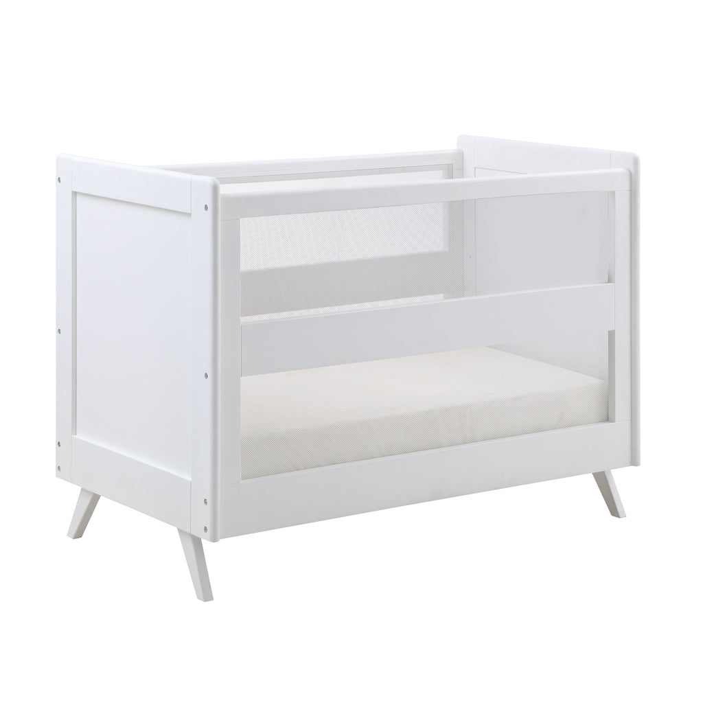 Angled Image of BreathableBaby Breathable Mesh 3-in-1 Convertible Crib in White on White Background