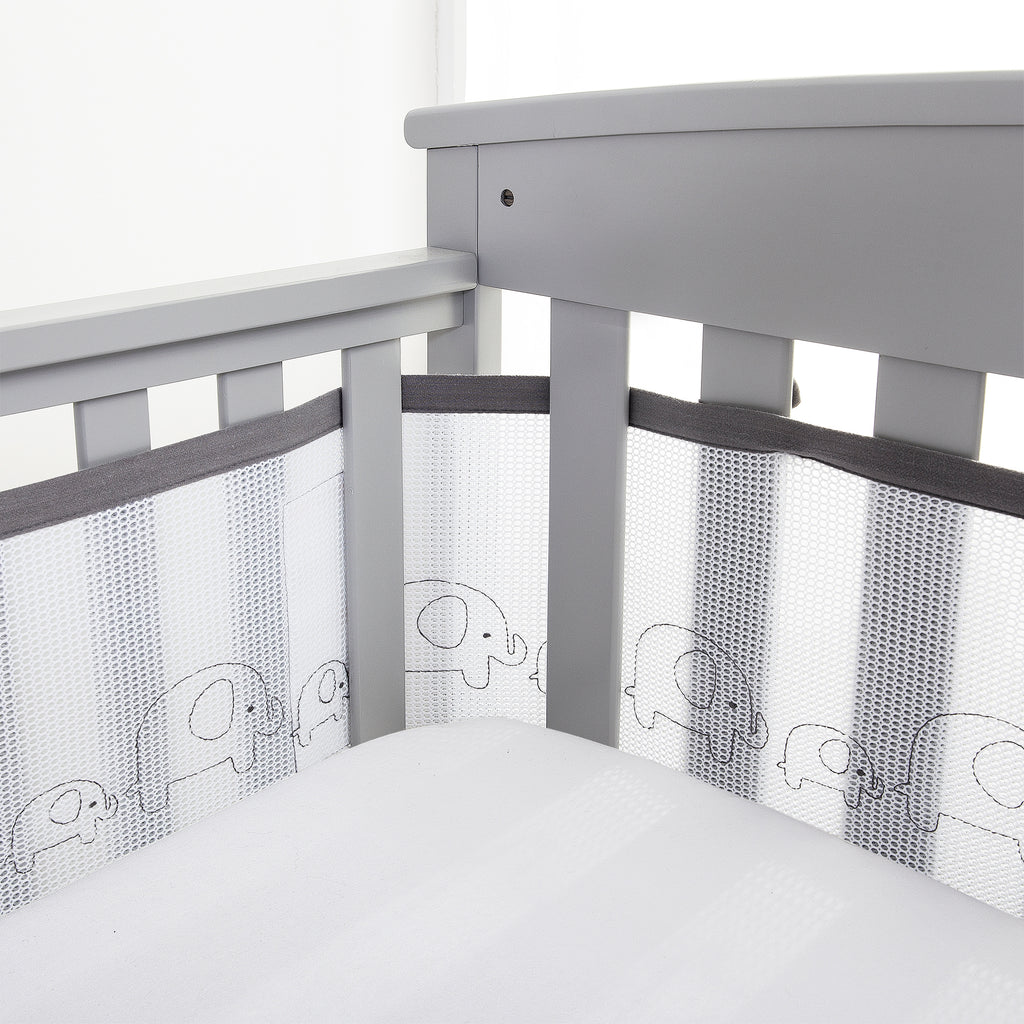 Corner view of BreathableBaby Breathable Mesh Crib Liner – Deluxe Embroidered Collection on a crib in Elephants
