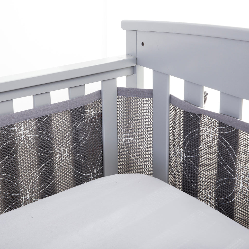 Corner view of BreathableBaby Breathable Mesh Crib Liner – Deluxe Embroidered Collection on a crib in Gray Links 