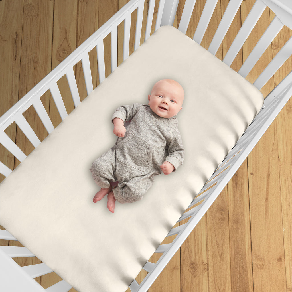 BreathableBaby All-in-One Fitted Sheet & Waterproof Cover for Crib Mattresses in Natural Ecru Shown in Crib