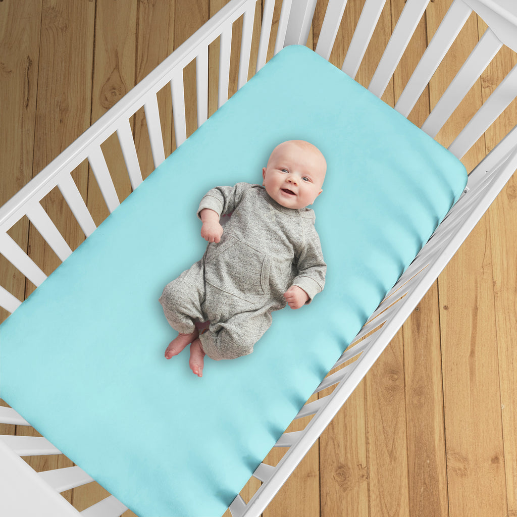 BreathableBaby All-in-One Fitted Sheet & Waterproof Cover for Crib Mattresses in Blue Green Aqua Shown in Crib