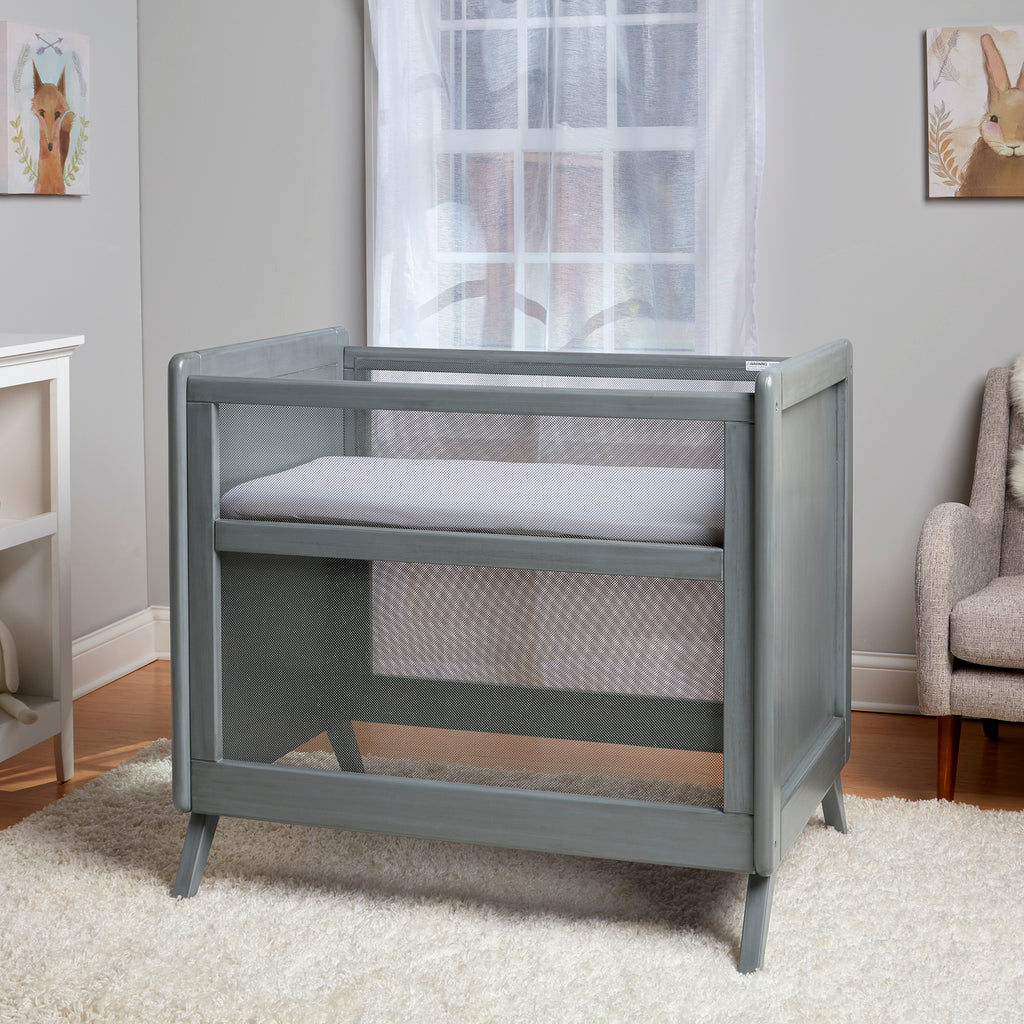 BreathableBaby Breathable Mesh 2-in-1 Mini Crib in Gray in Nursery Setting