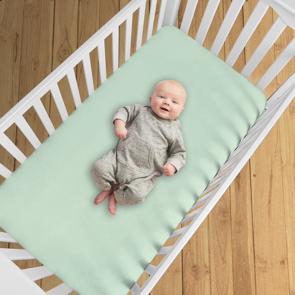 BreathableBaby All-in-One Fitted Sheet & Waterproof Cover for Crib Mattresses in Mint Green Shown in Crib