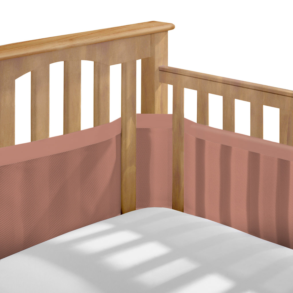 Corner view of BreathableBaby Breathable Mesh Crib Liner – Deluxe Muslin Collection on a crib in Red Clay