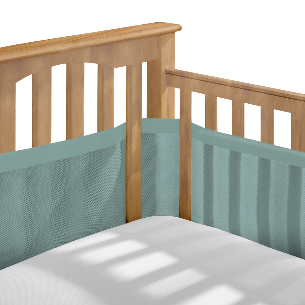 Corner view of BreathableBaby Breathable Mesh Crib Liner – Deluxe Muslin Collection on a crib in Green Seaglass