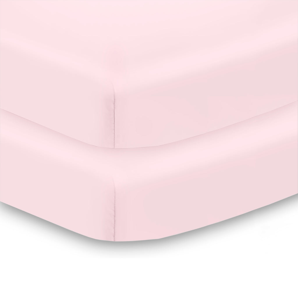 Corner View of BreathableBaby All-in-One Fitted Sheet & Waterproof Cover for Mini Crib Mattresses in Light Pink