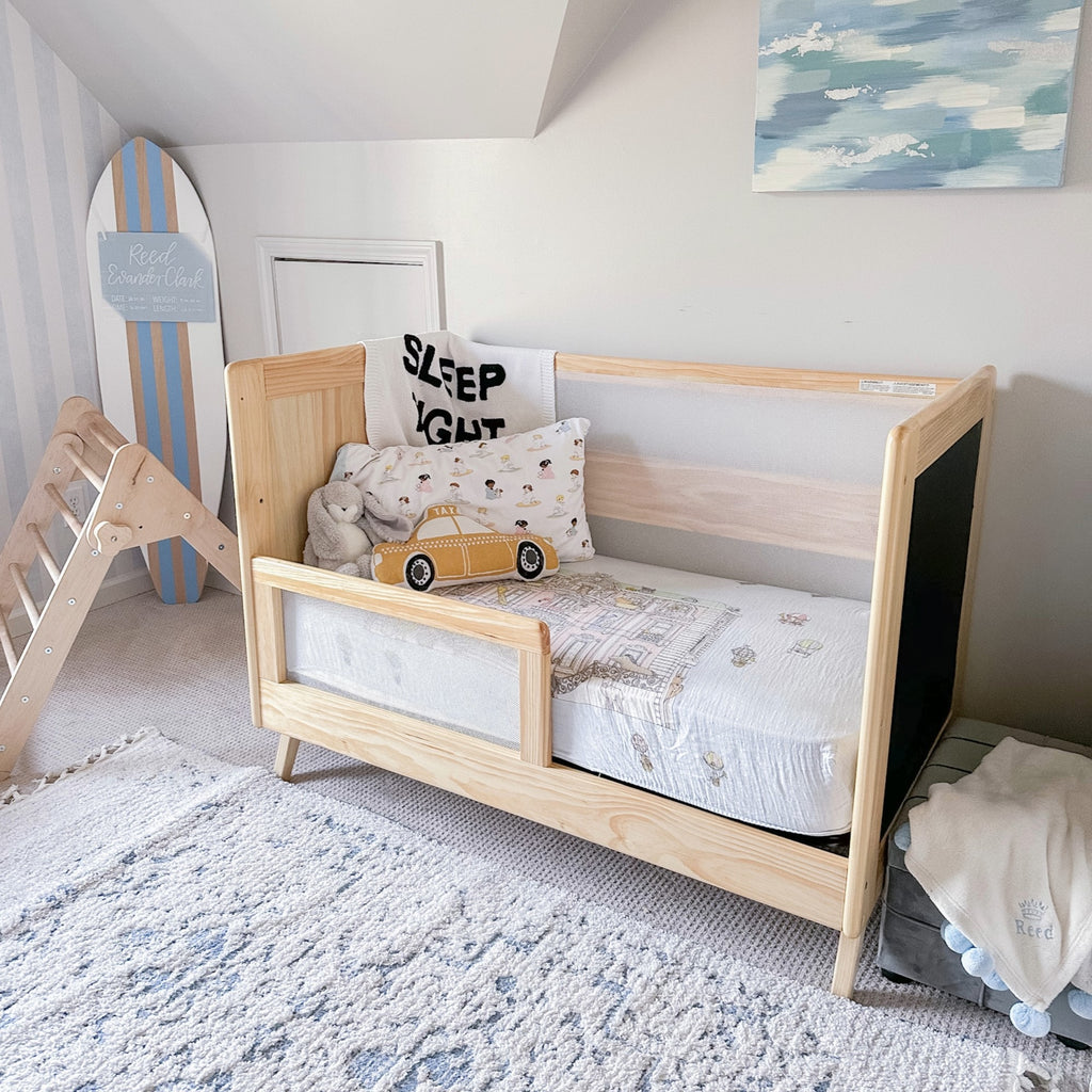 BreathableBaby Breathable Mesh Toddler Bed Conversion Kit in Beech shown on converted toddler bed in nursery setting