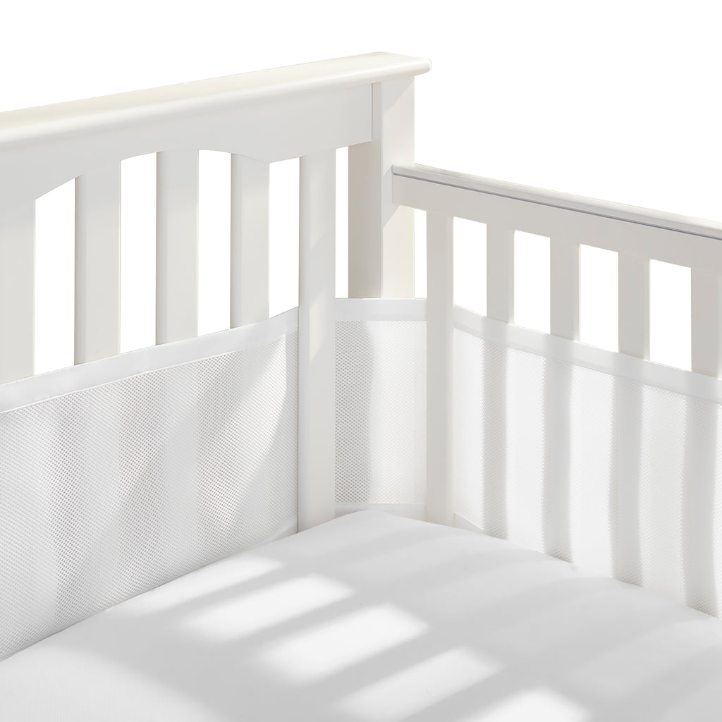 Corner view of BreathableBaby Breathable Mesh Crib Liner on a crib in White