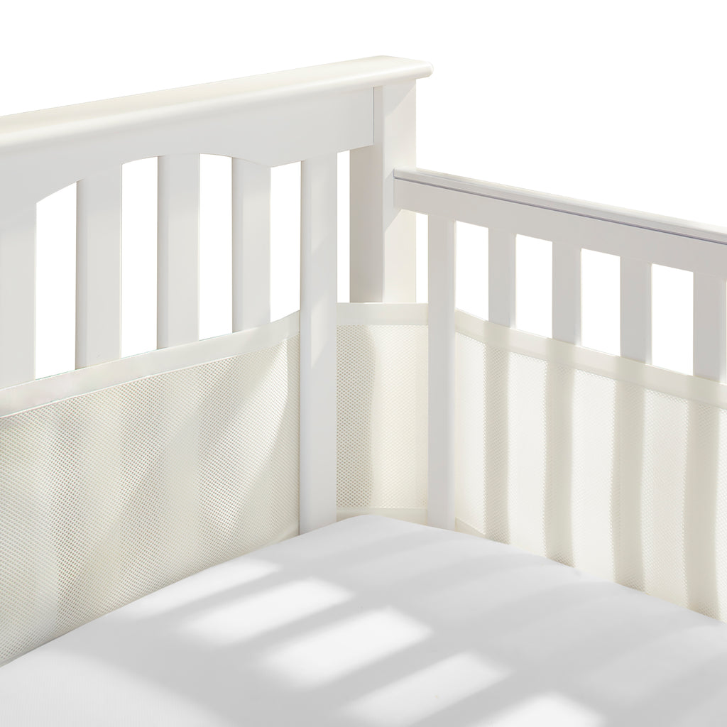 Corner view of BreathableBaby Breathable Mesh Crib Liner on a crib in Natural Ecru