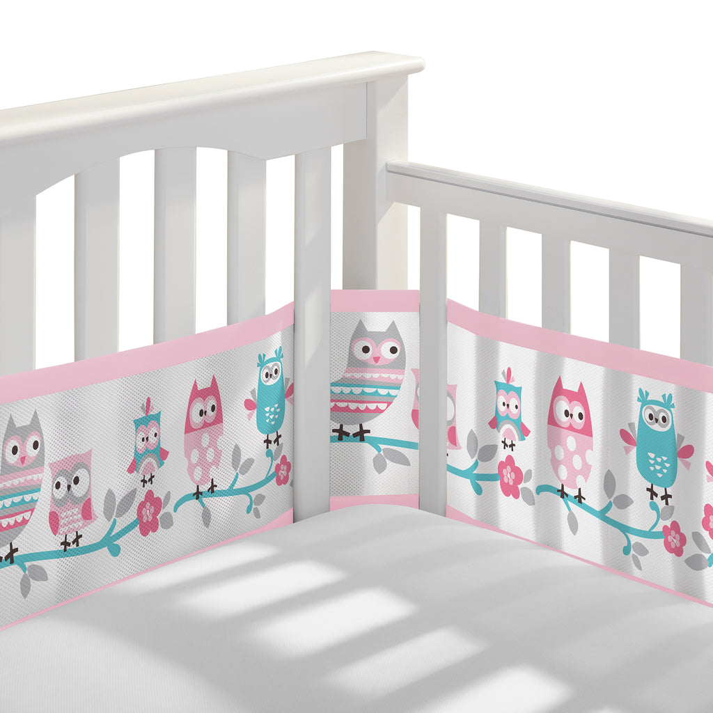 Corner view of BreathableBaby Breathable Mesh Crib Liner on a crib in Owl Fun Pink