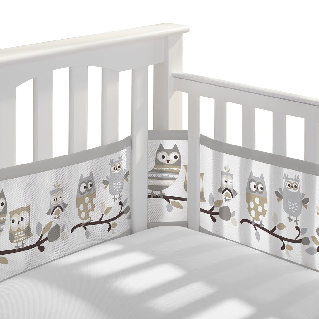Corner view of BreathableBaby Breathable Mesh Crib Liner on a crib in Owl Fun Gray