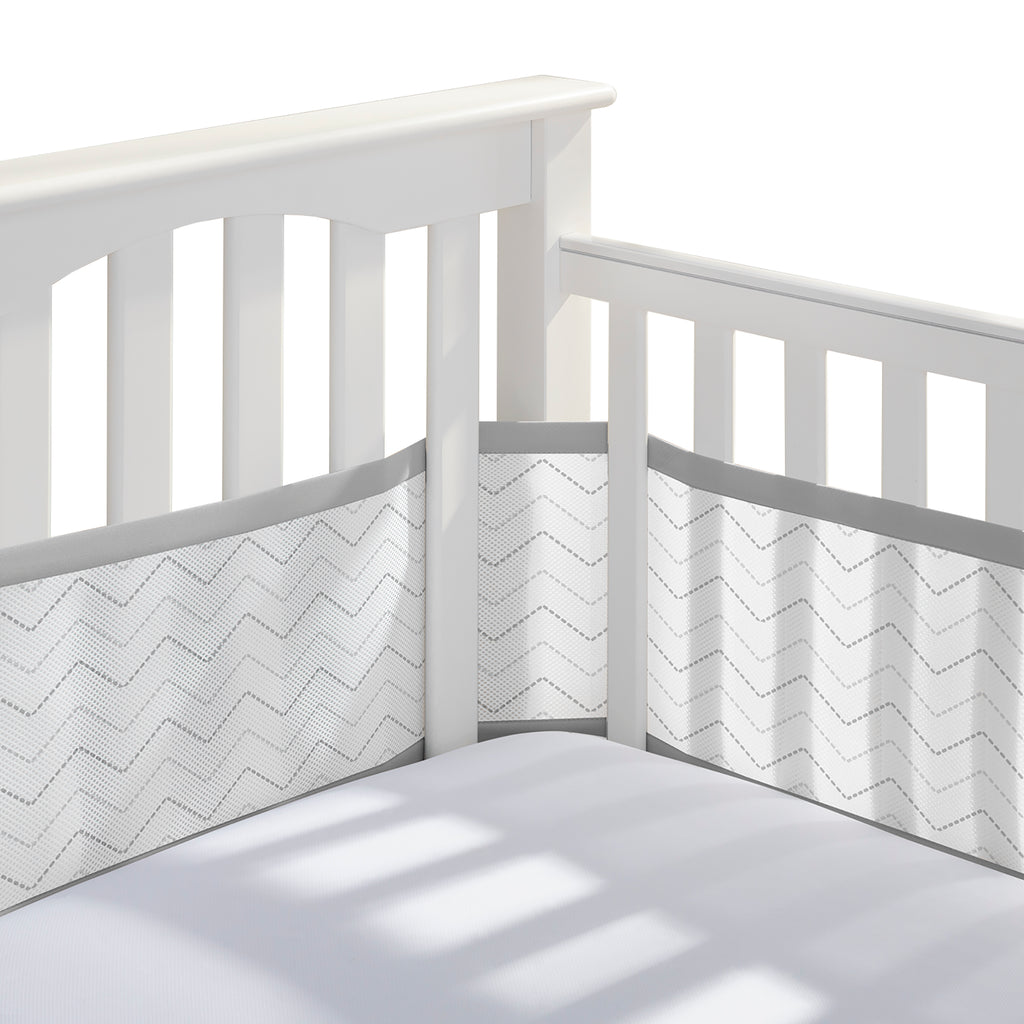 Corner view of BreathableBaby Breathable Mesh Crib Liner on a crib in Gray Chevron