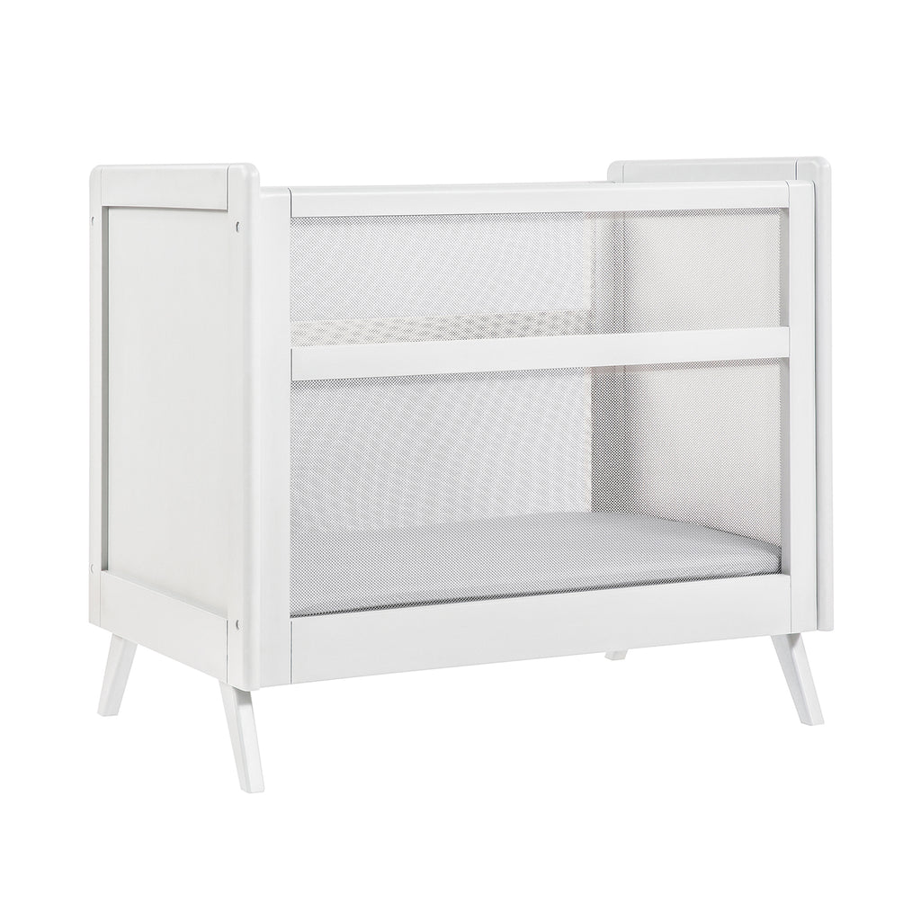 Angled Image of BreathableBaby Breathable Mesh 2-in-1 Mini Crib in White on White Background