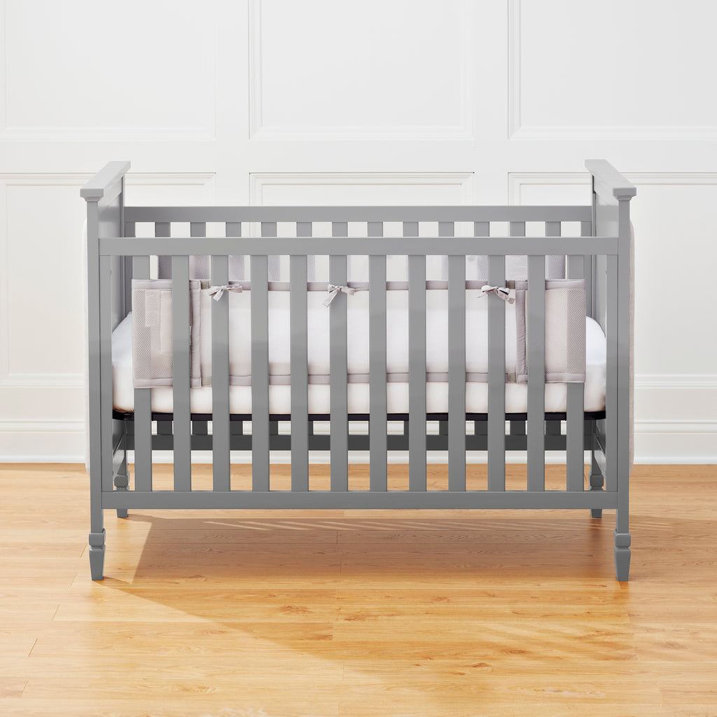 Full crib view of BreathableBaby Breathable Mesh Crib Liner on a solid end crib in Gray