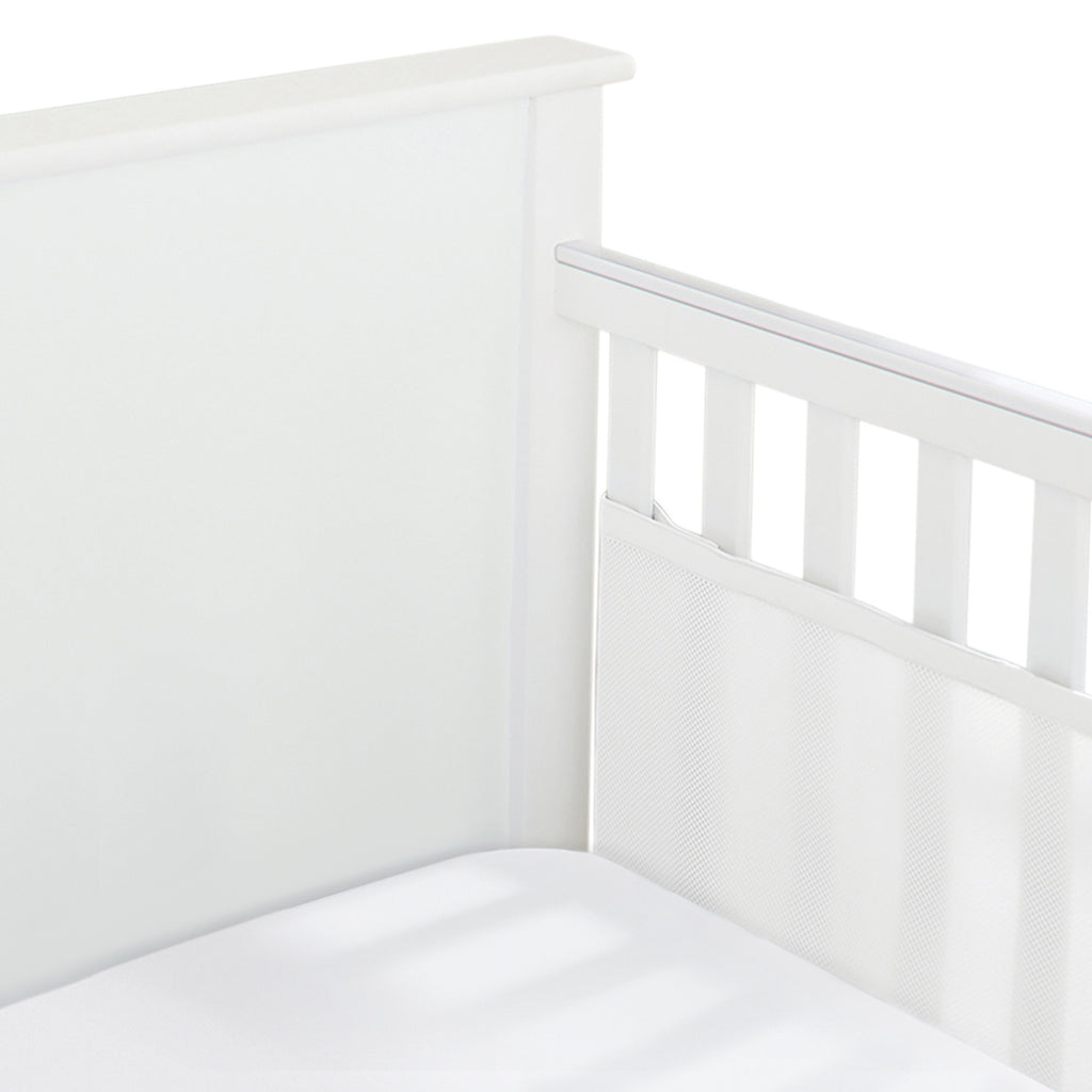 Corner view of BreathableBaby Breathable Mesh Crib Liner on a solid end crib in White