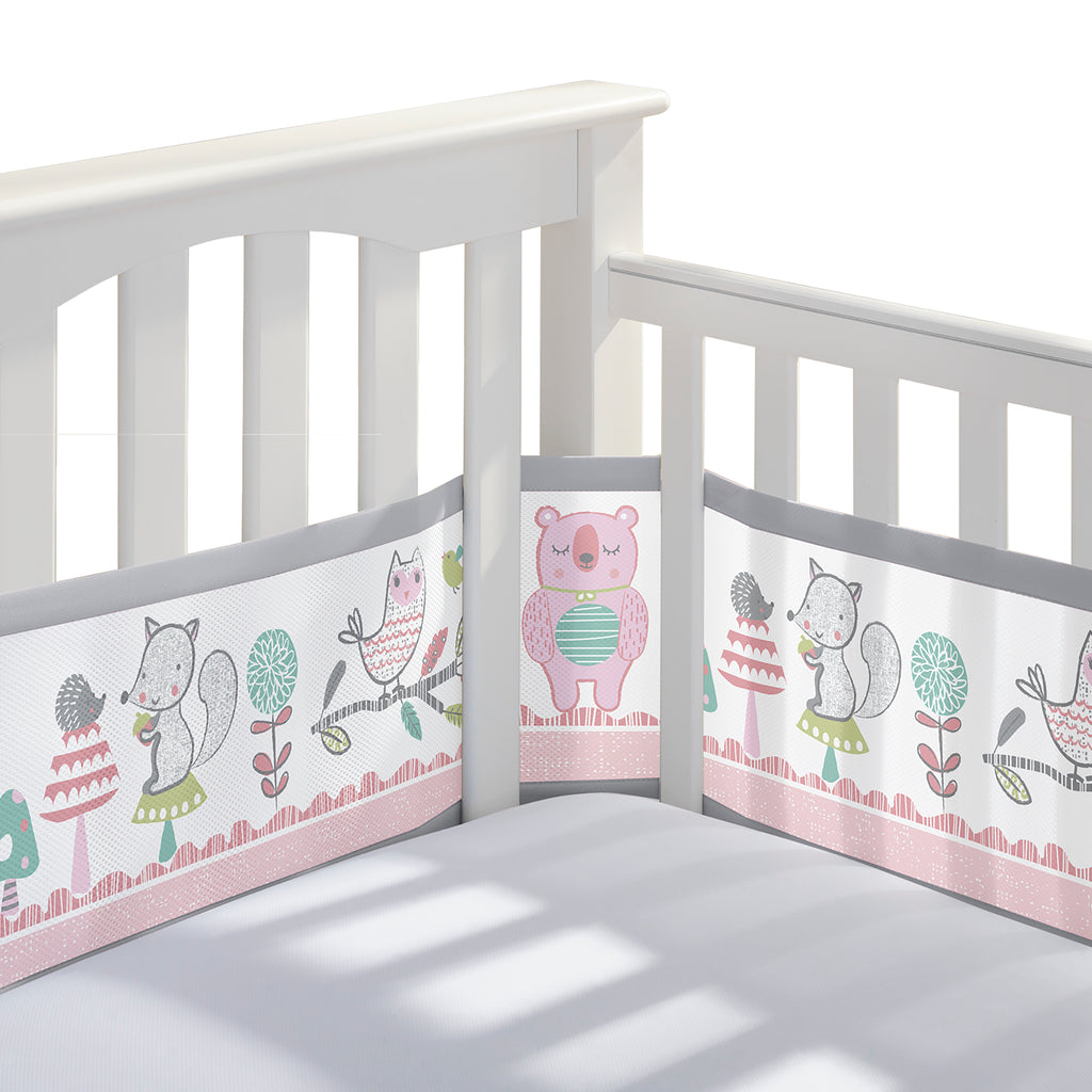 Corner view of BreathableBaby Breathable Mesh Crib Liner on a crib in Forest Fun Pink print