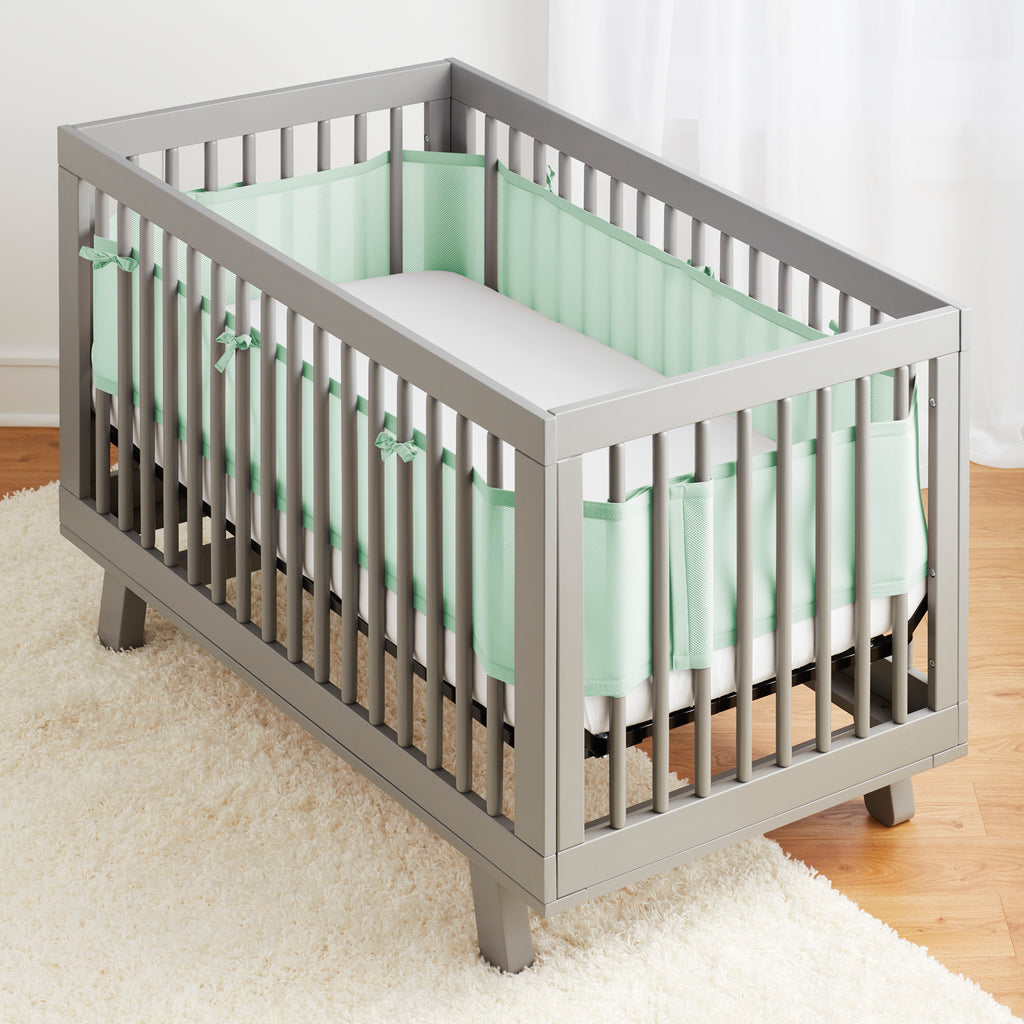 Full crib view of BreathableBaby Breathable Mesh Crib Liner on a crib in Mint Green