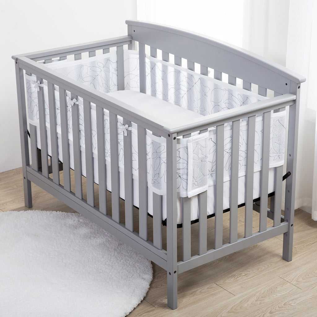 Full crib view of BreathableBaby Breathable Mesh Crib Liner – Deluxe Embroidered Collection on a crib in Feathered Friends