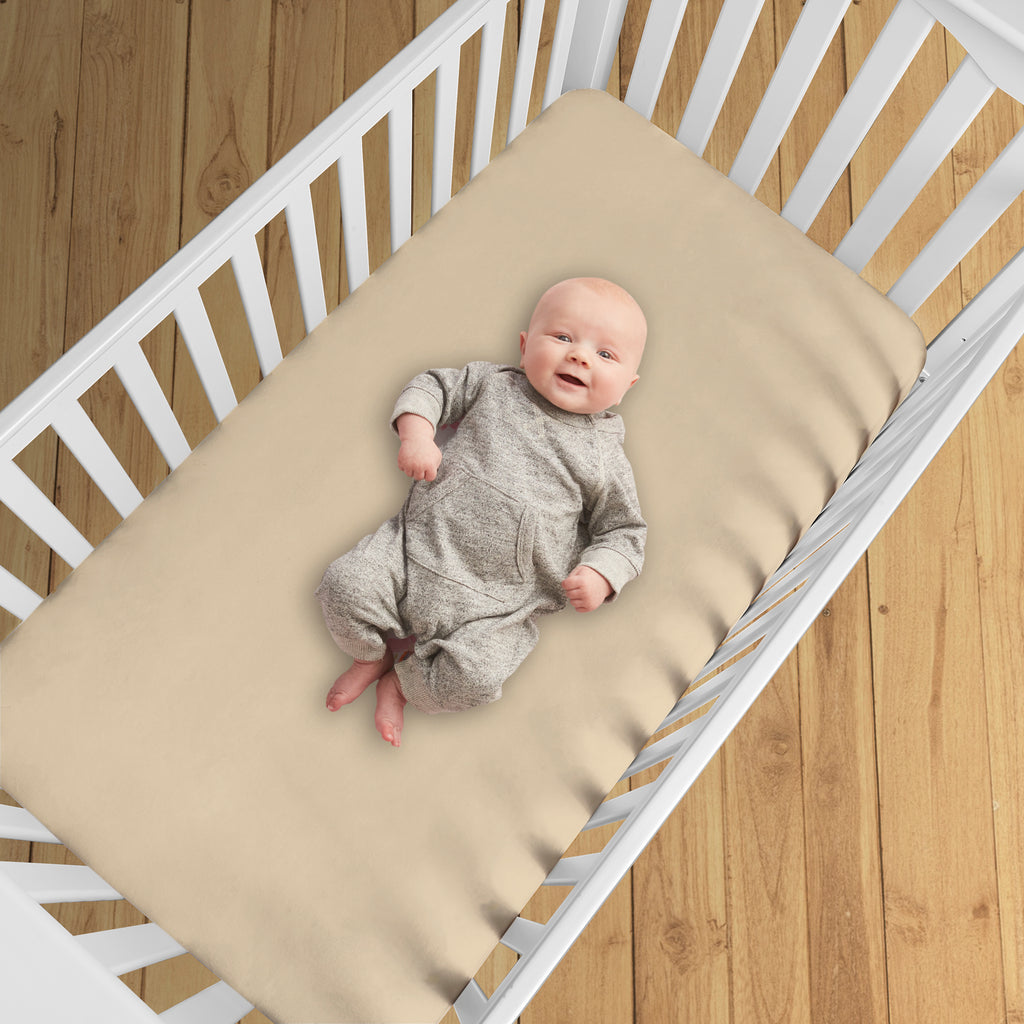 BreathableBaby All-in-One Fitted Sheet & Waterproof Cover for Crib Mattresses in Beige Shown in Crib