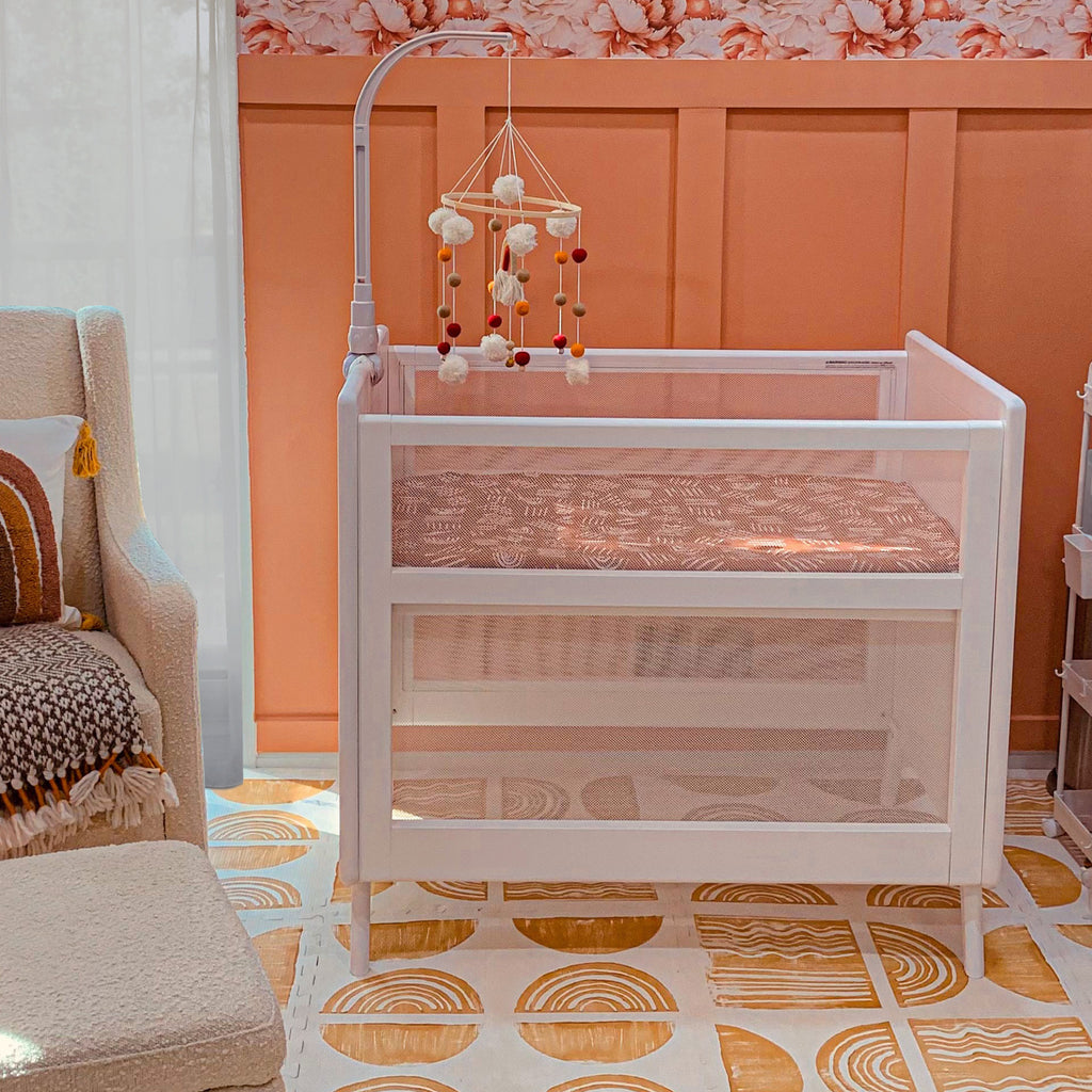 BreathableBaby Breathable Mesh 2-in-1 Mini Crib in White in Nursery Setting